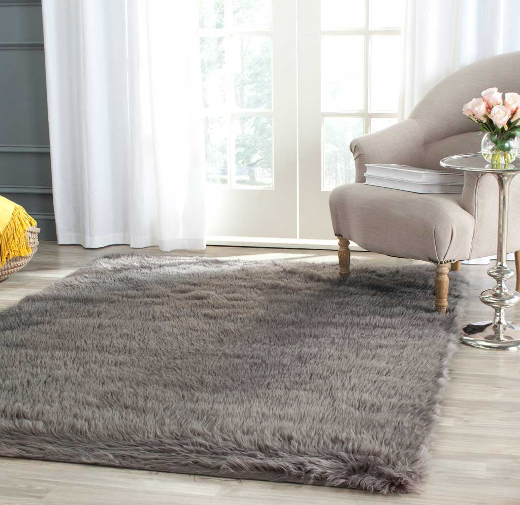 Thick gray shag rug adds a cozy layer beneath an upholstered chair and side table
