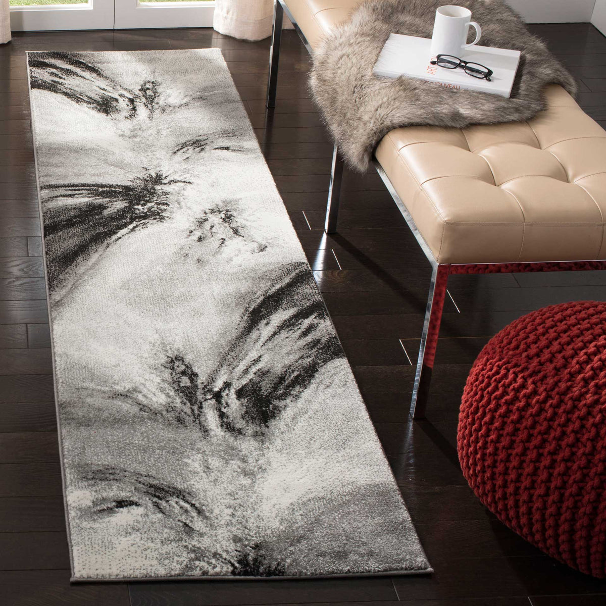 Flowing charcoal swirls give this light gray runner a striking modern look