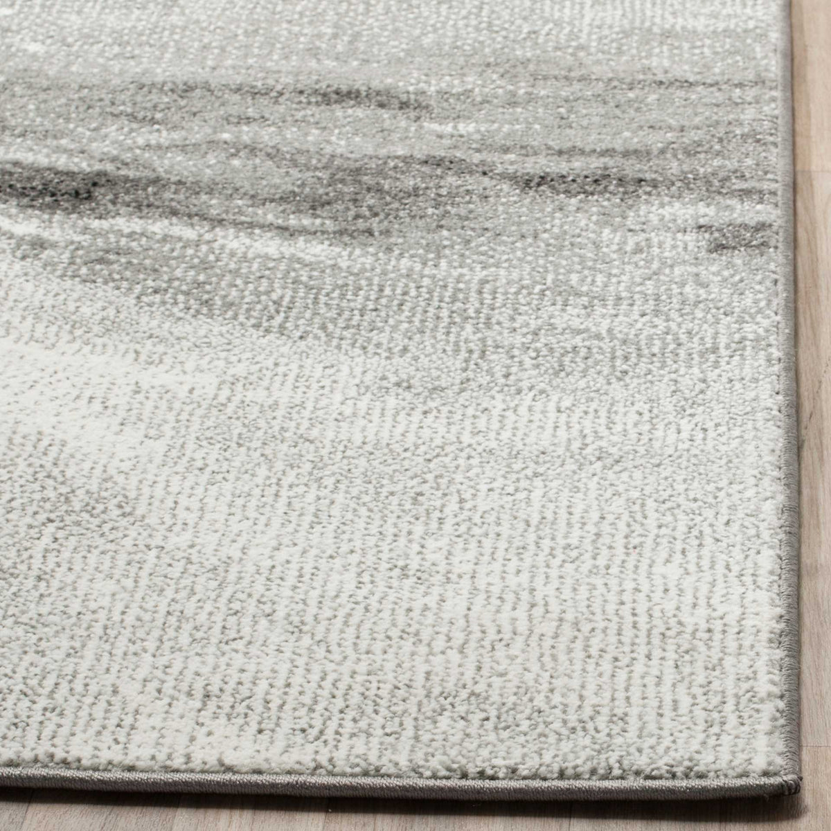 Soft gray-and-ivory pile with subtle shading and a neatly bound edge