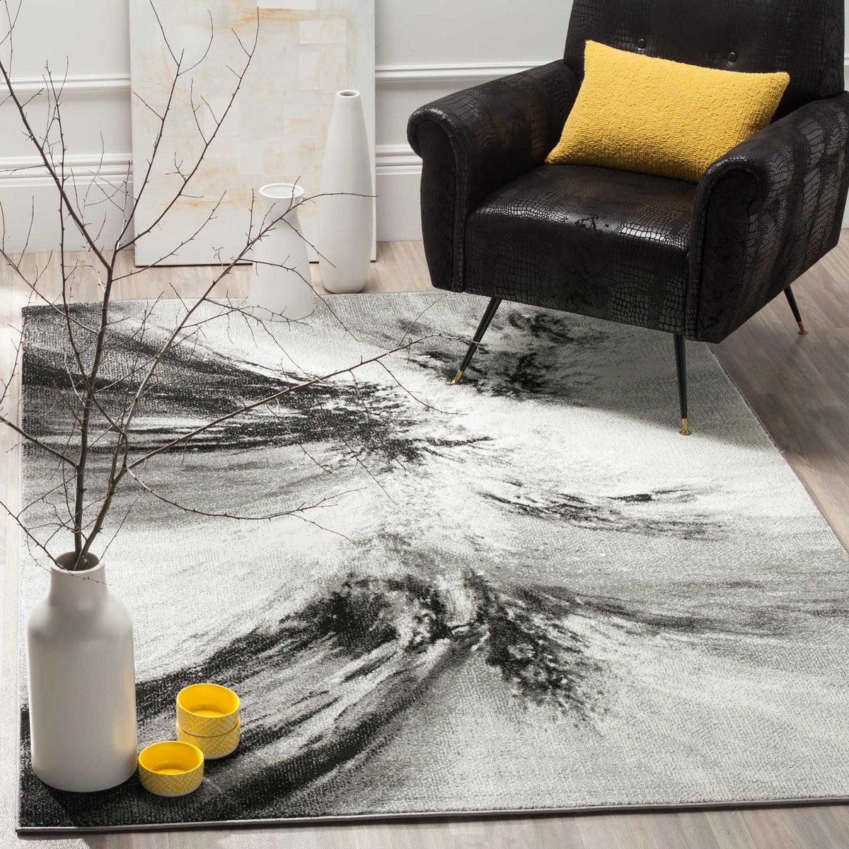 Sweeping charcoal patterns make this ivory area rug a bold foundation beneath a lounge chair