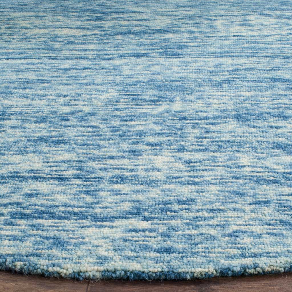 Blue and ivory wool pile shows subtle texture and a neatly finished edge