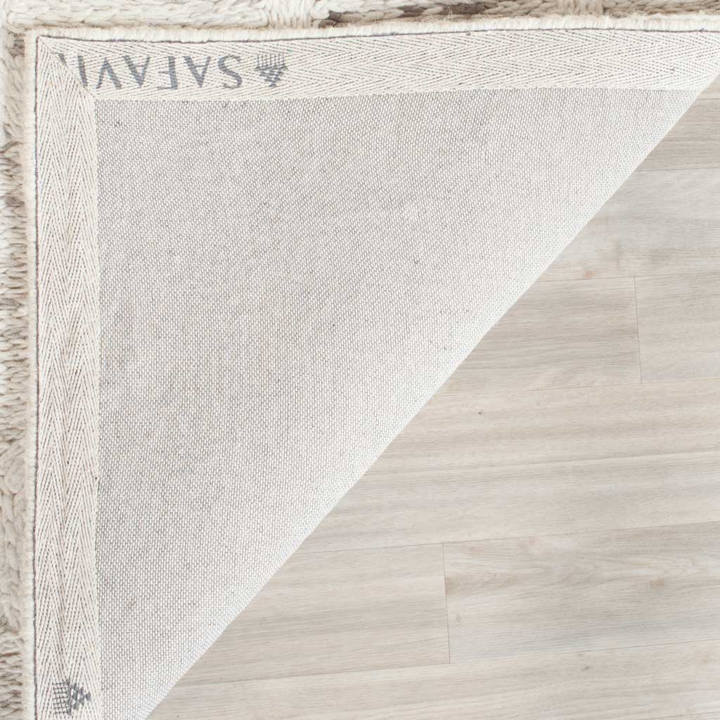 Woven cotton backing and neatly bound edges finish the gray and ivory wool rug