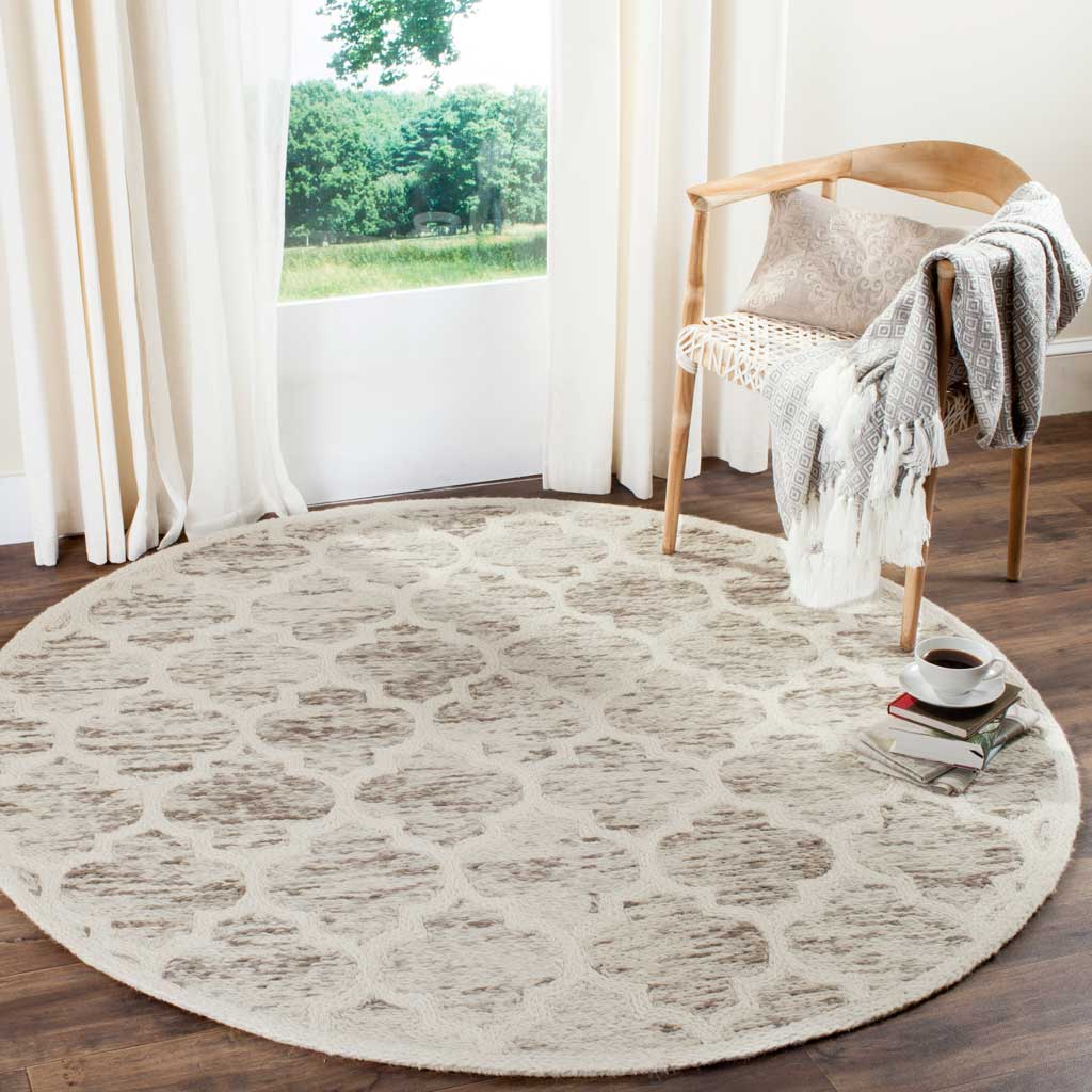 Subtle gray and ivory motifs give this round wool rug a calm, textured presence
