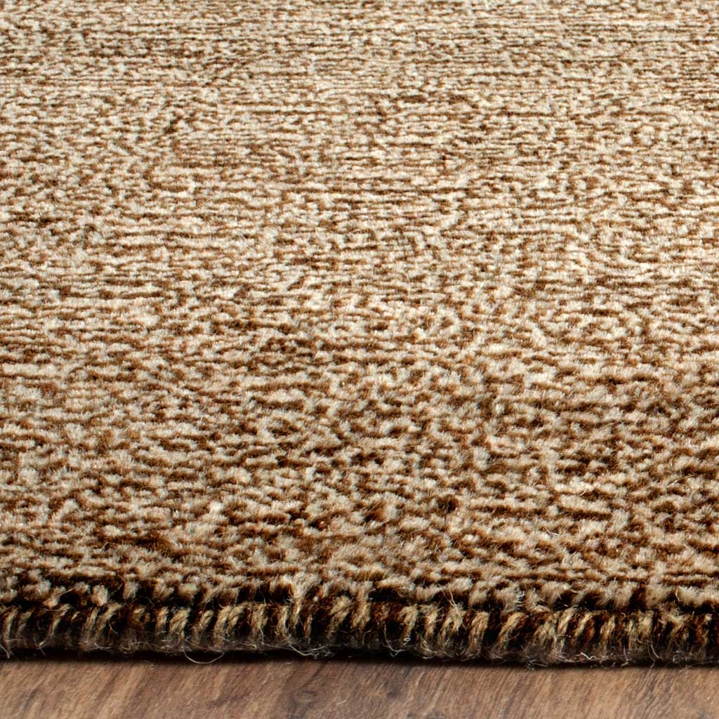 Variegated brown and cream yarns form a textured surface above a neatly finished edge