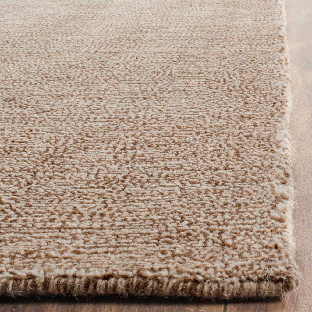 Brown wool-blend fibers and a finished edge highlight the rug's hand-loomed texture
