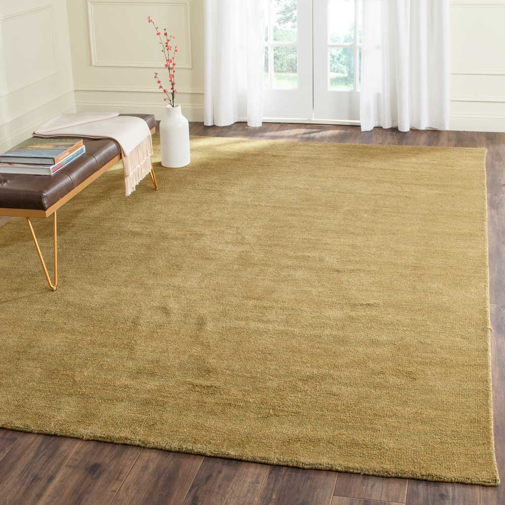 Muted olive green rug adds organic warmth to a sunlit room with dark wood floors