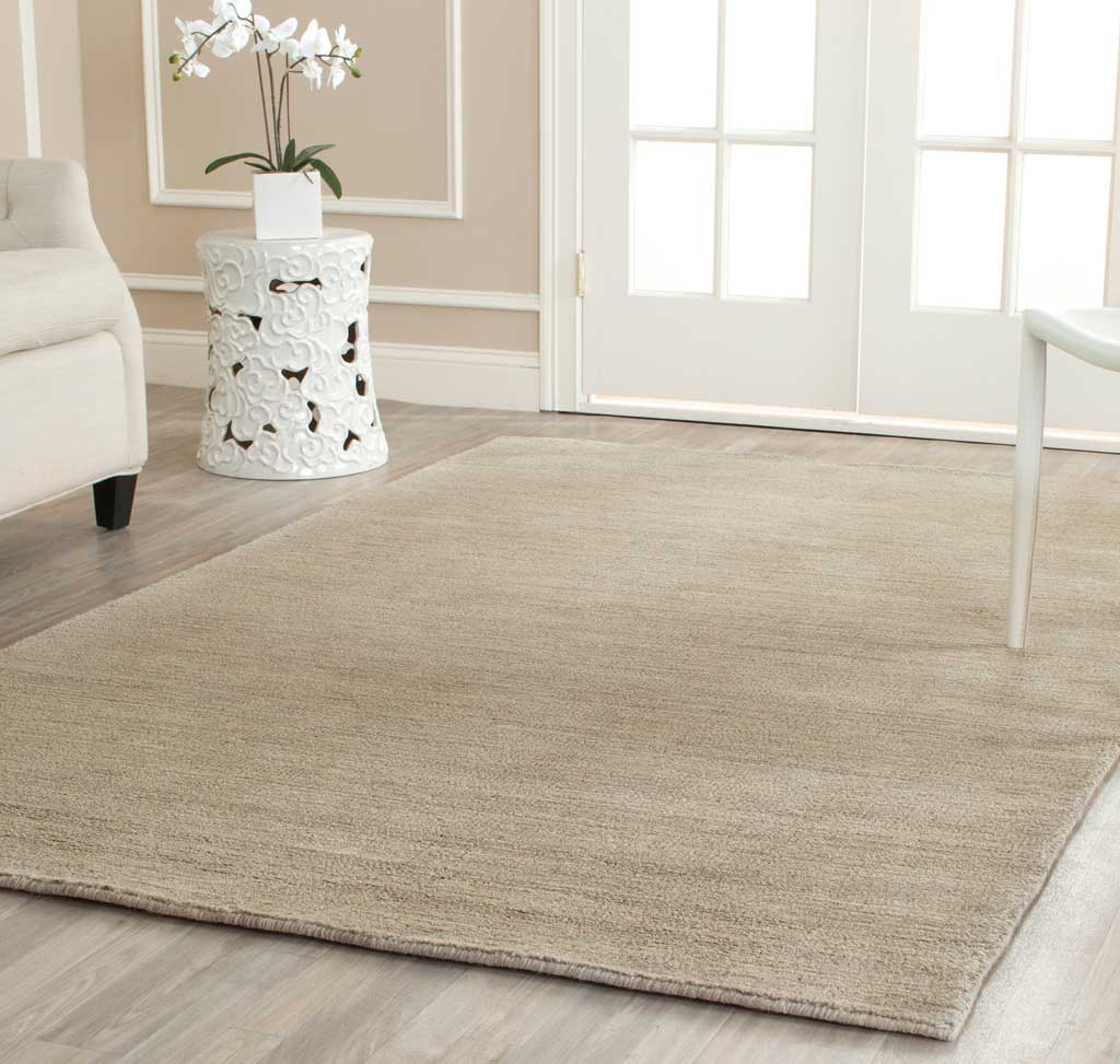 Light gray rug anchors a bright seating area with delicate tonal texture