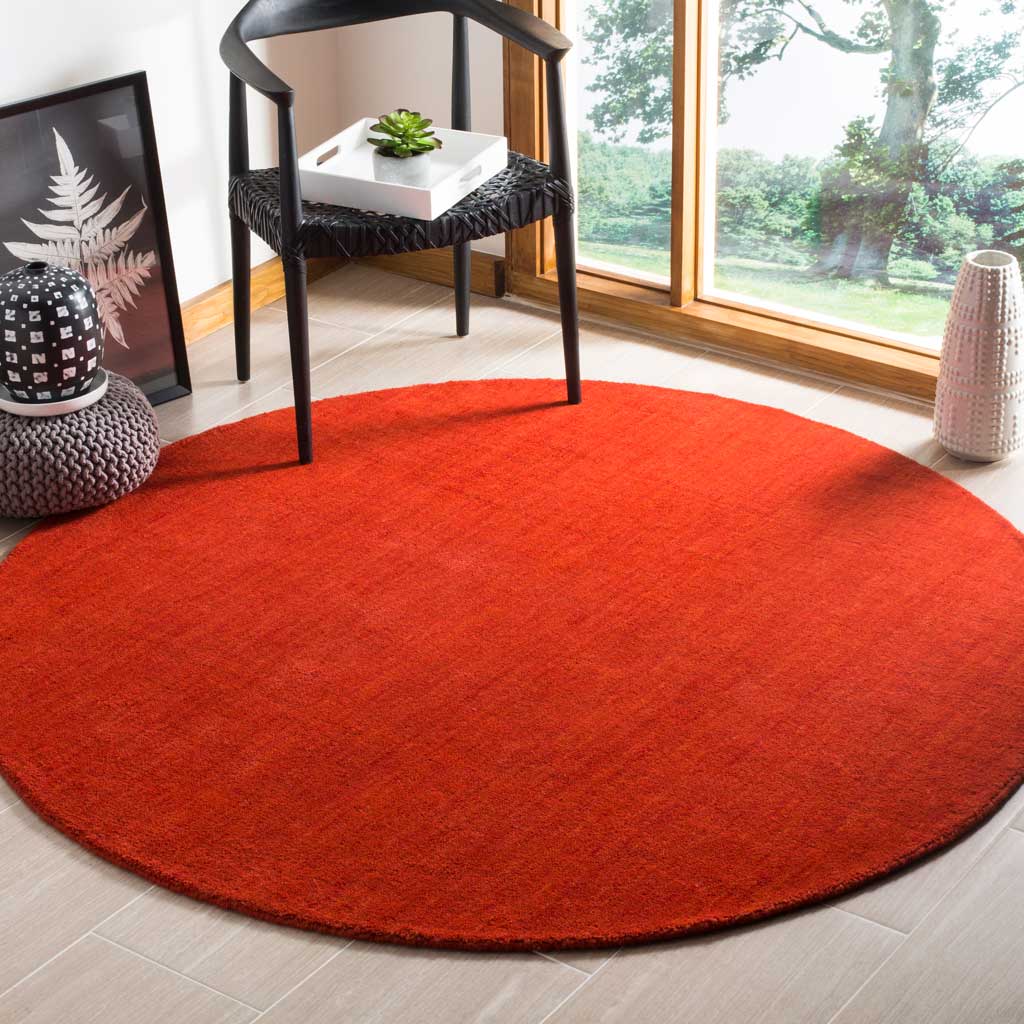 Bold red round rug brings warm color and soft texture to a modern seating area