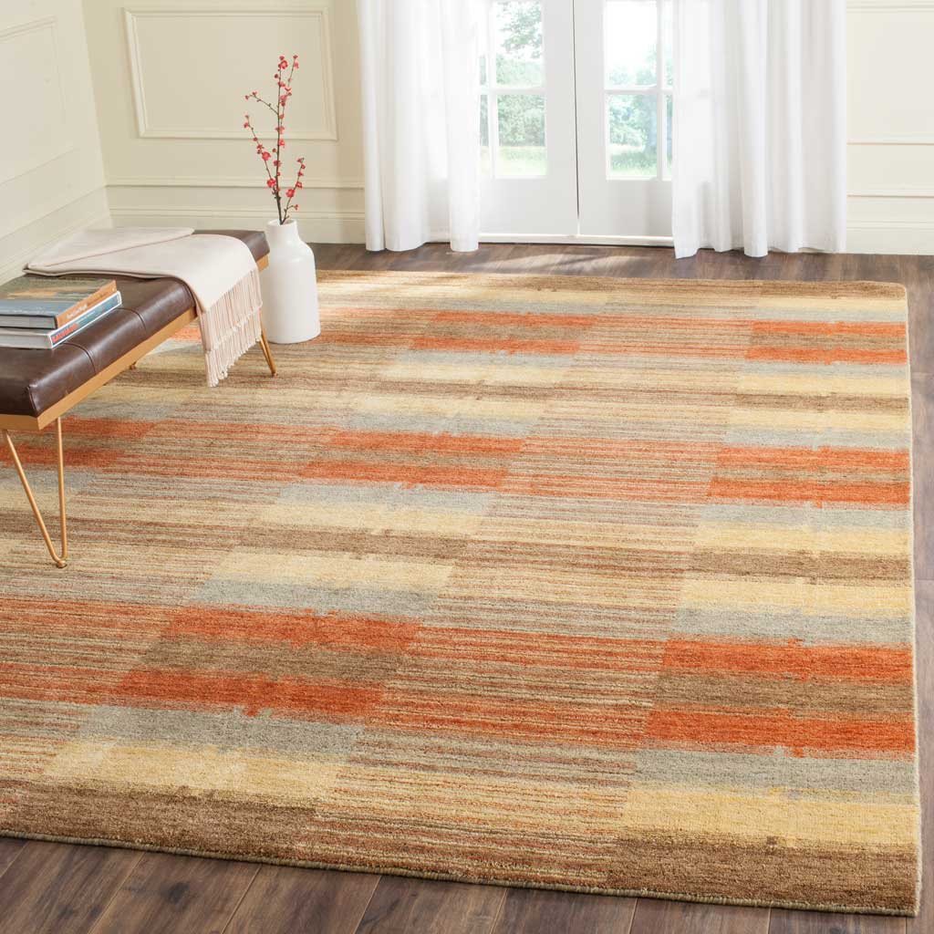 Warm rust, gold and gray stripes bring color and texture to a bright living room.