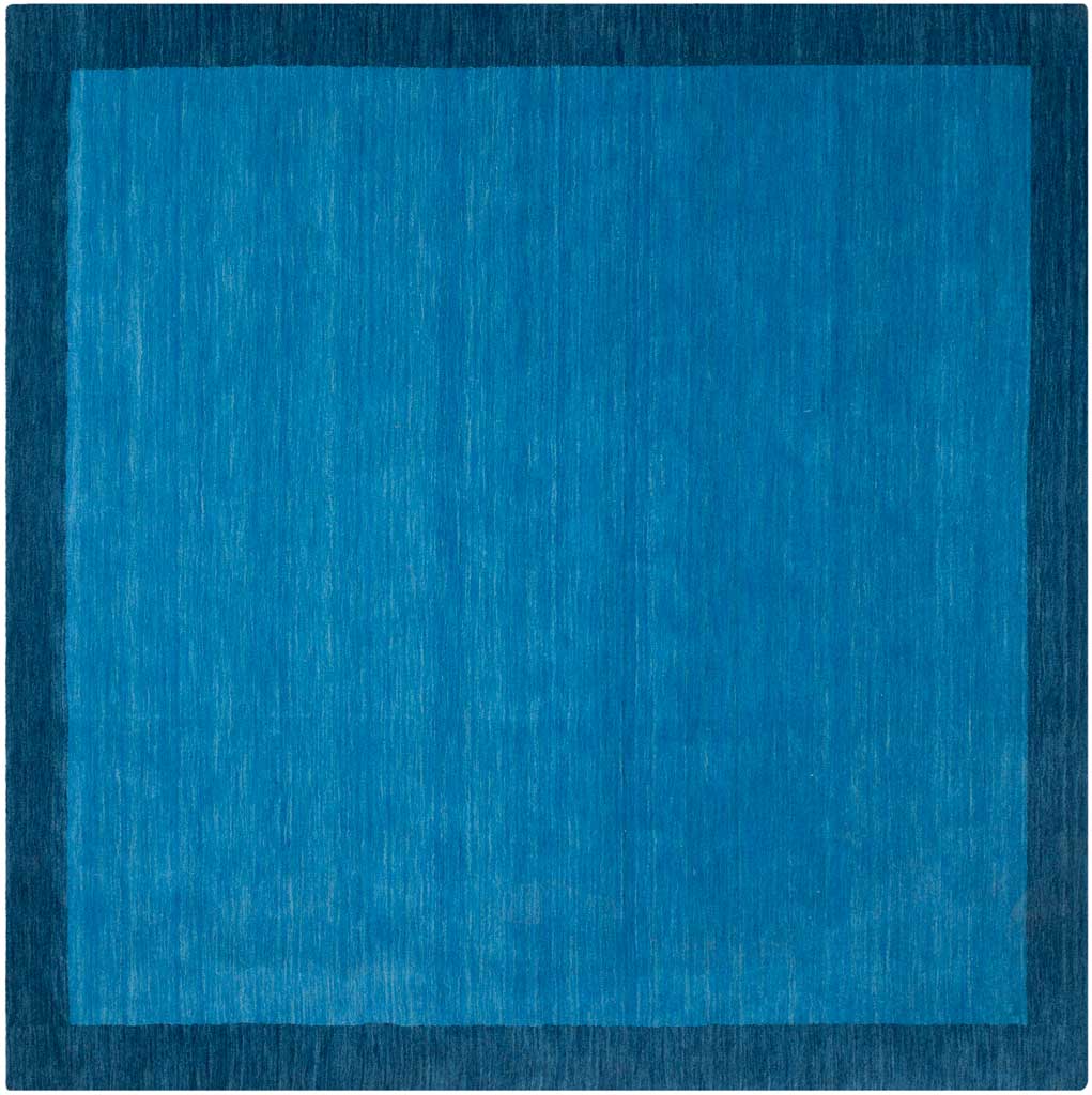 A square wool rug with a luminous blue field edged in dark blue