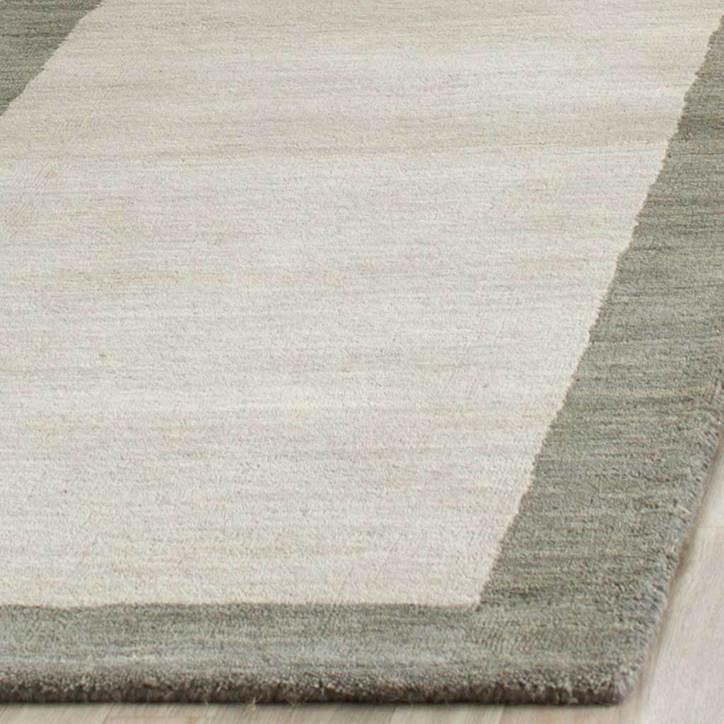 Textured light gray wool meets a deeper gray border at the neatly finished edge