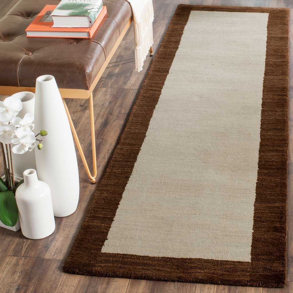 A slim two-tone wool runner adds warmth beside a leather bench