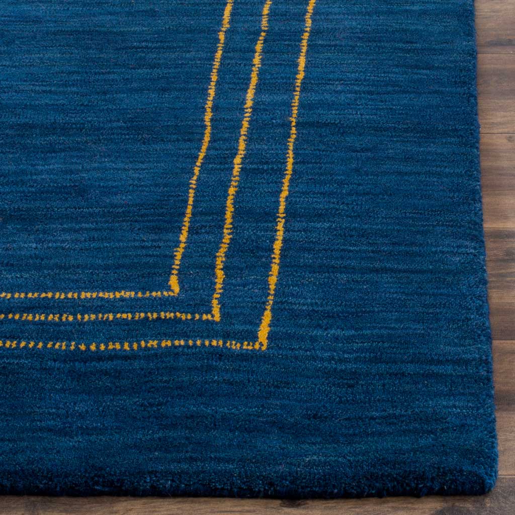 Slender gold border lines contrast with textured blue wool and a softly finished edge
