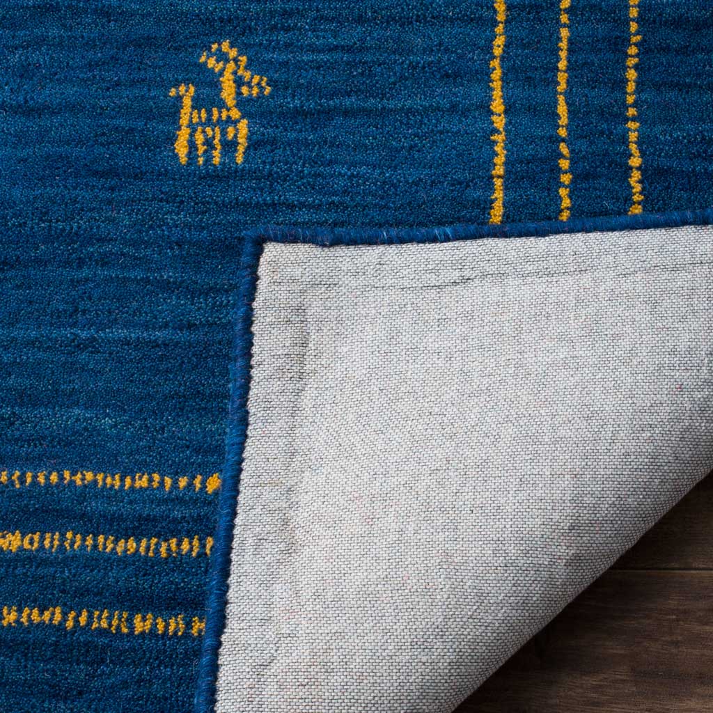 Folded blue wool reveals light cotton backing beneath a gold border and playful motif