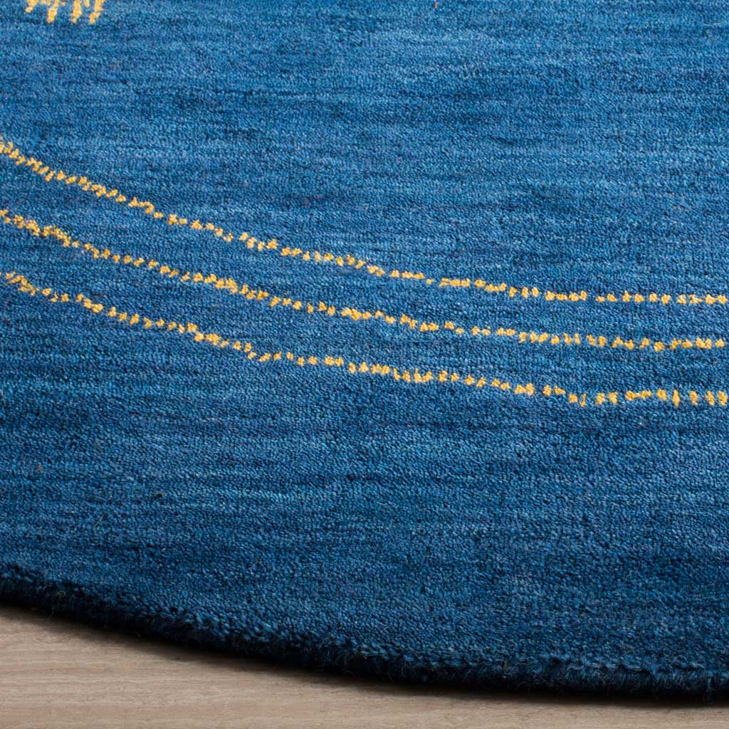 Dense blue wool pile meets fine gold rings and a neatly finished curved edge