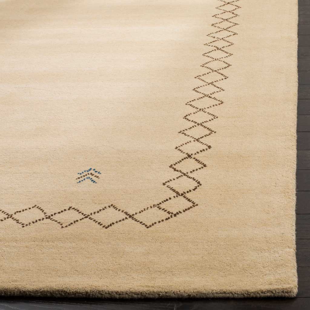 Soft beige wool pile with dark diamond lines, blue chevrons and a neatly finished edge