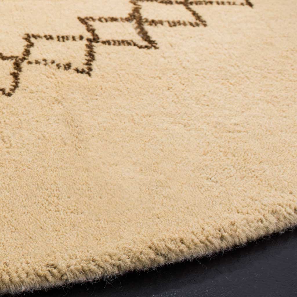 Plush beige wool pile with dark geometric lines and a softly finished edge