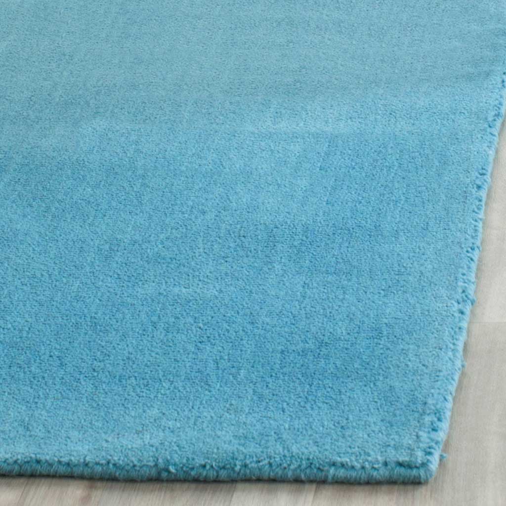 Plush turquoise pile and a carefully finished edge offer inviting texture.