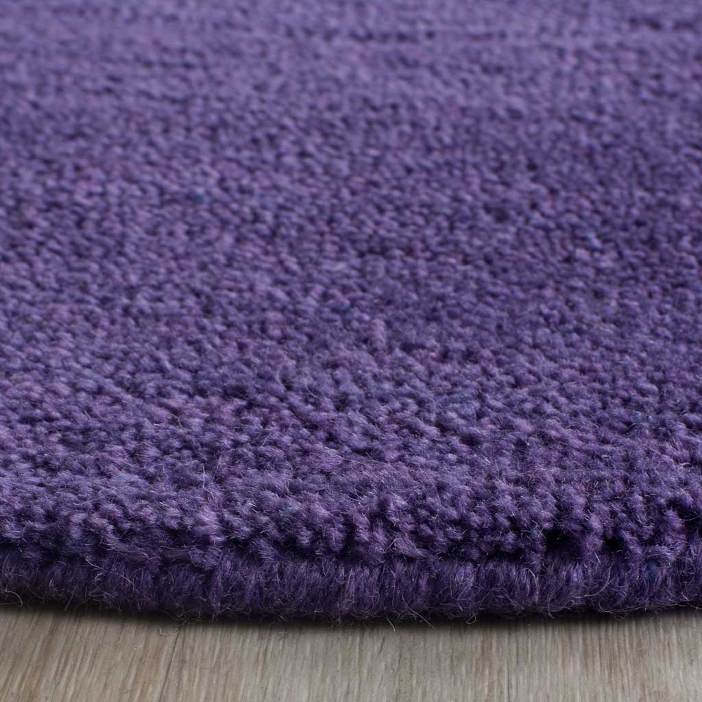 Plush purple fibers and a substantial edge create inviting underfoot texture