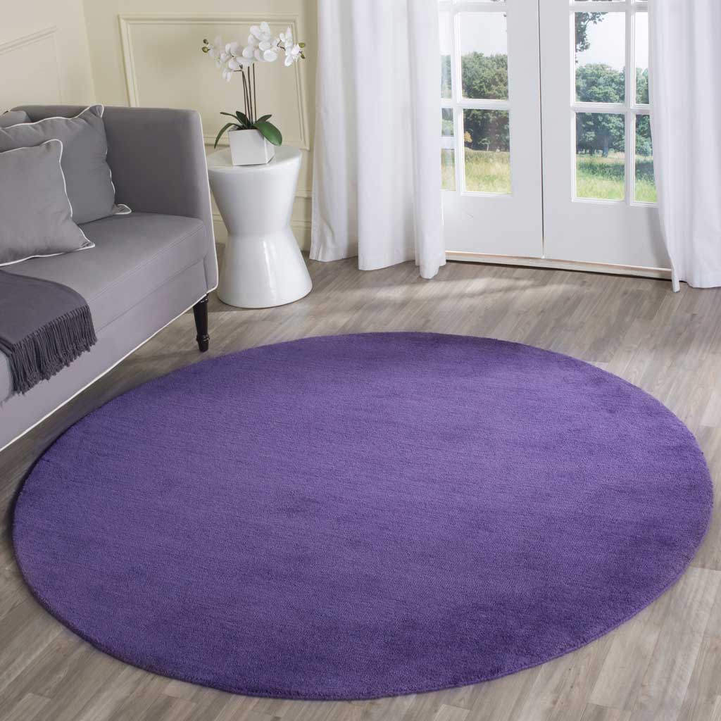 Vibrant purple round rug makes a cozy, colorful centerpiece for a sitting area