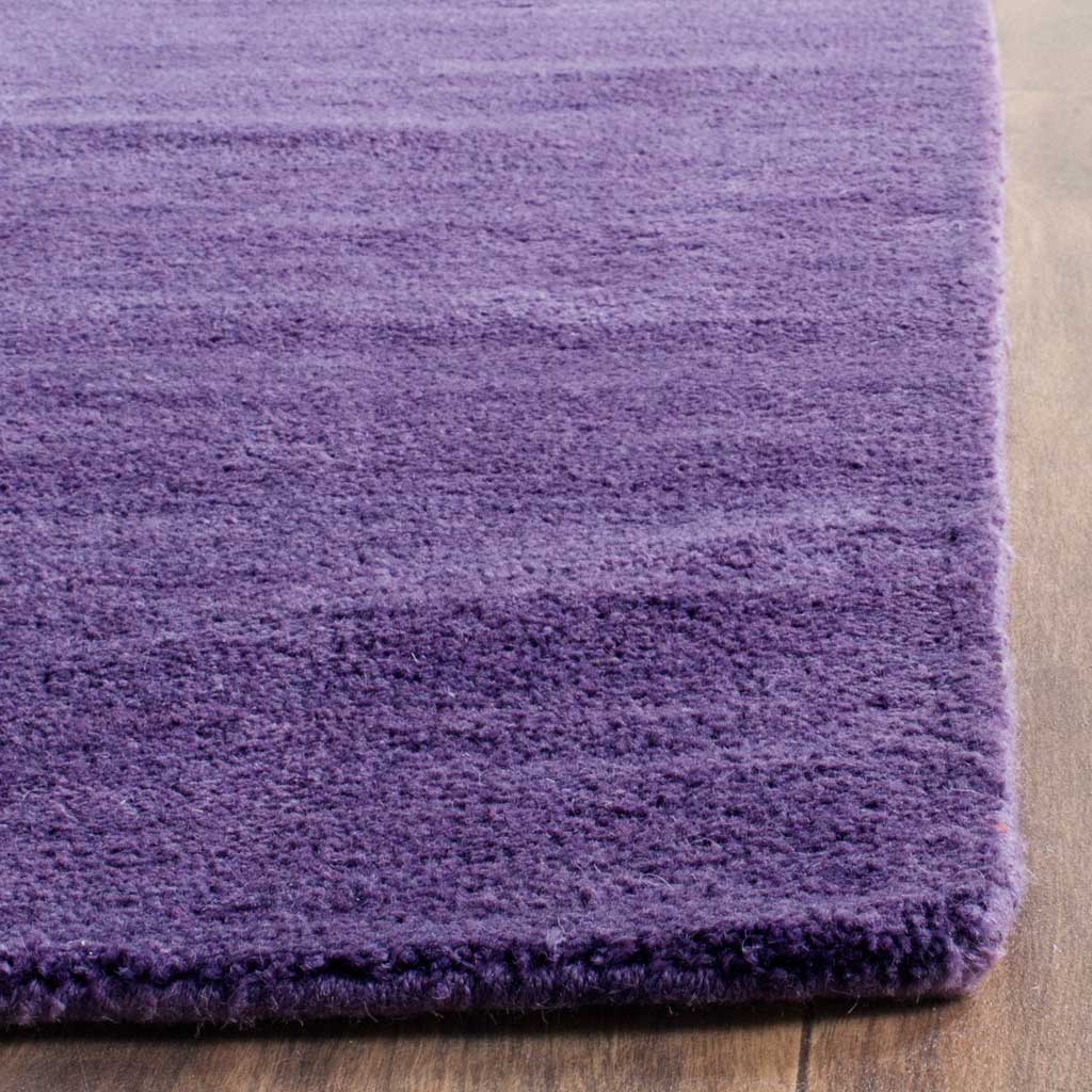 Thick violet pile and a tidy finished corner bring depth to this richly toned rug
