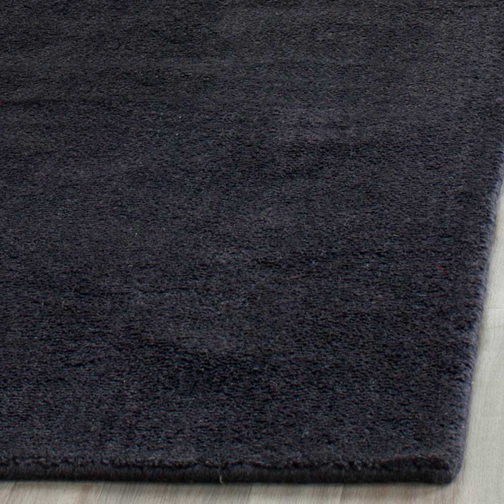 Dense black pile and a tidy finished edge bring rich texture to this runner.