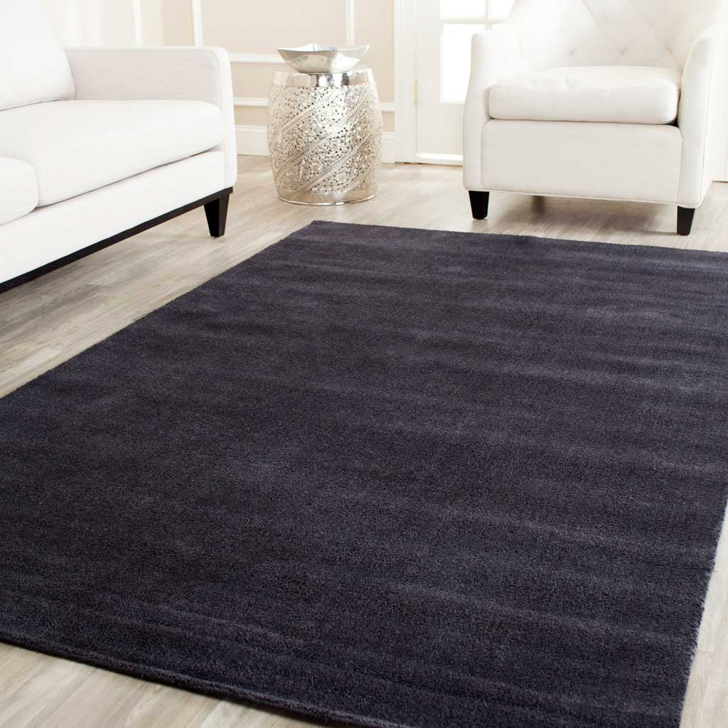 Dark black rug brings rich contrast and a soft surface to a light seating area