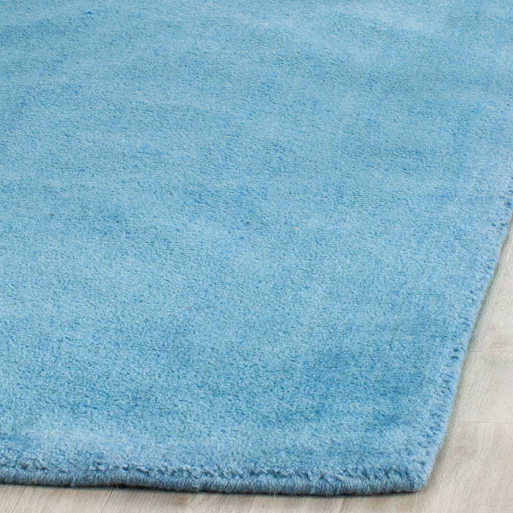 Softly textured blue pile and a neatly finished edge add cozy definition.