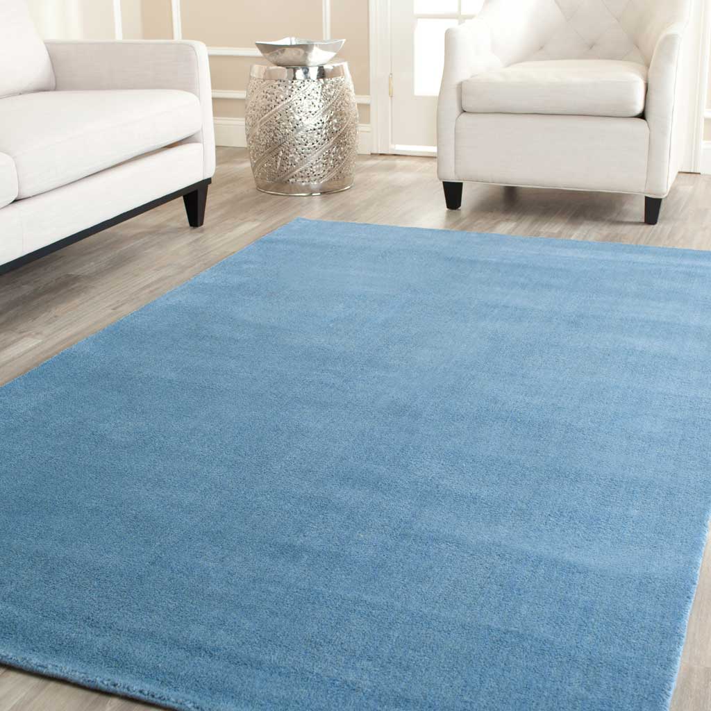 Blue tonal rug pairs plush texture with a cool, airy palette in a bright seating space