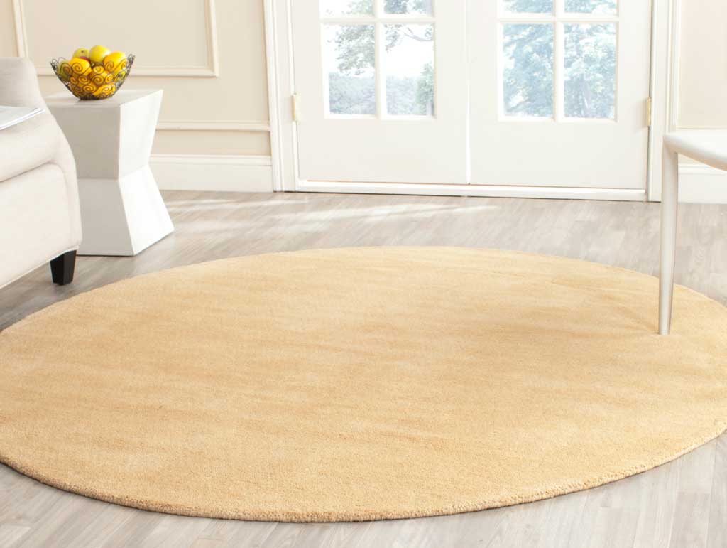Soft beige round rug defines the room with gentle color and understated texture