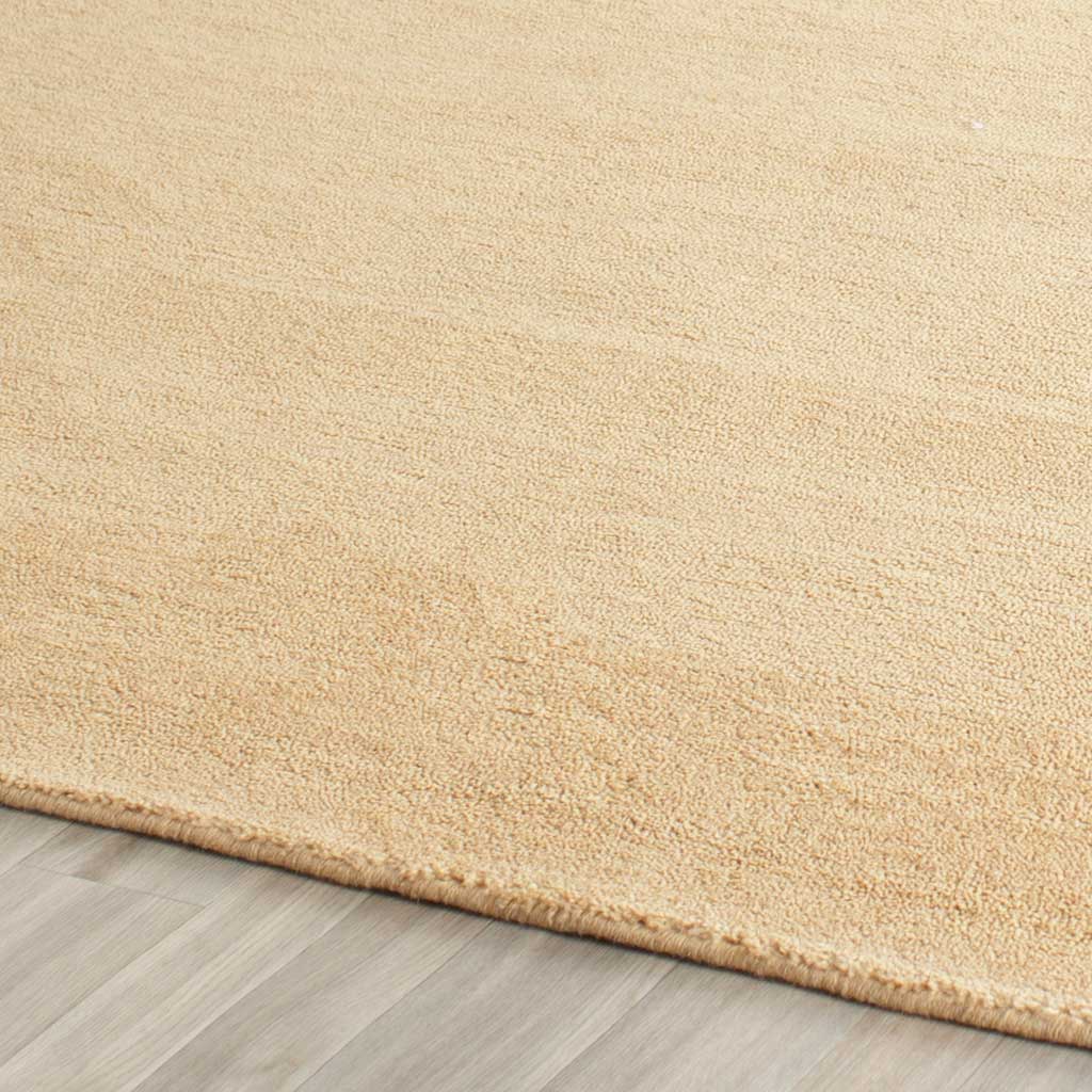 Subtle beige color shifts complement the softly textured pile and neatly bound rug edge