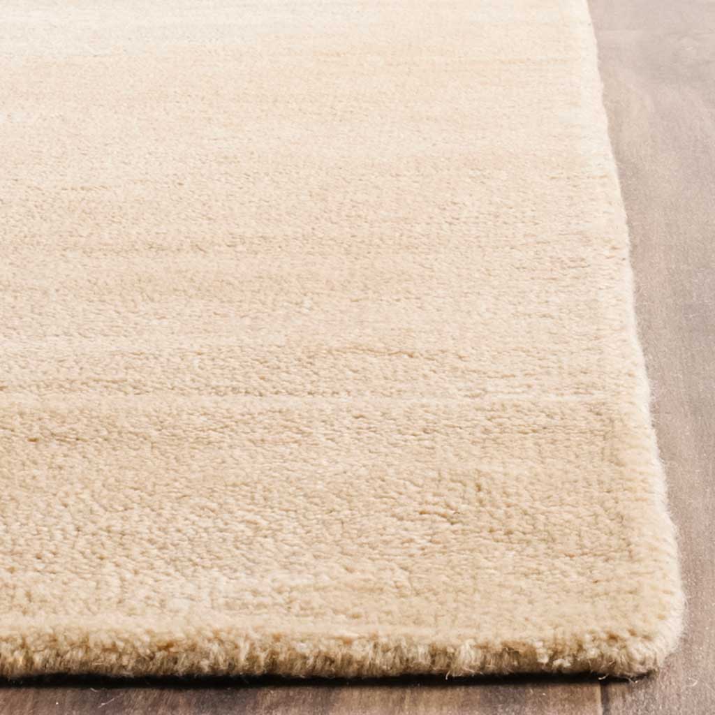 Plush beige pile meets a tidy finished corner, emphasizing the rug's soft texture