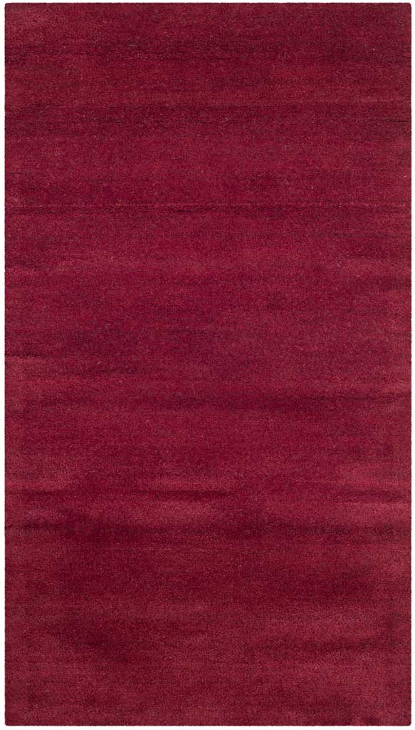 Narrow red accent rug layers deep crimson tones across a clean, borderless shape