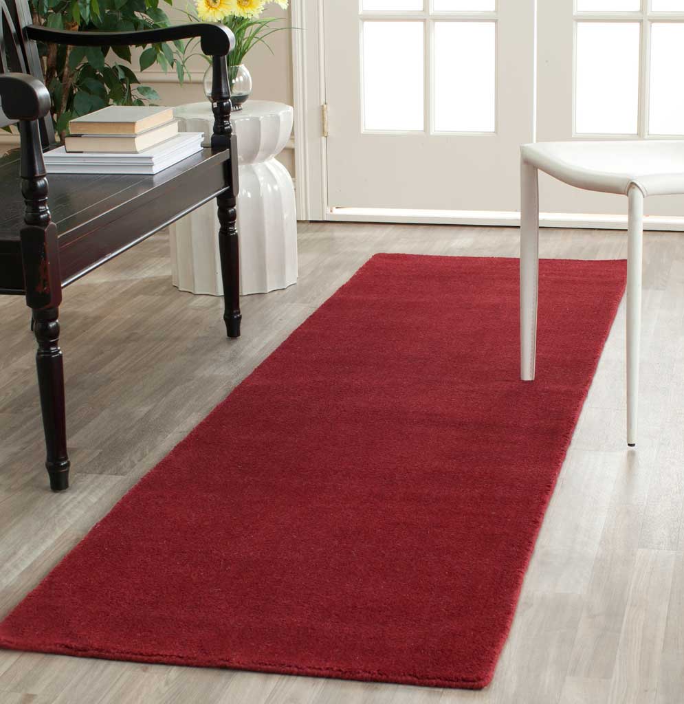 Red runner brings warmth and a bold color accent to a light-filled entryway.