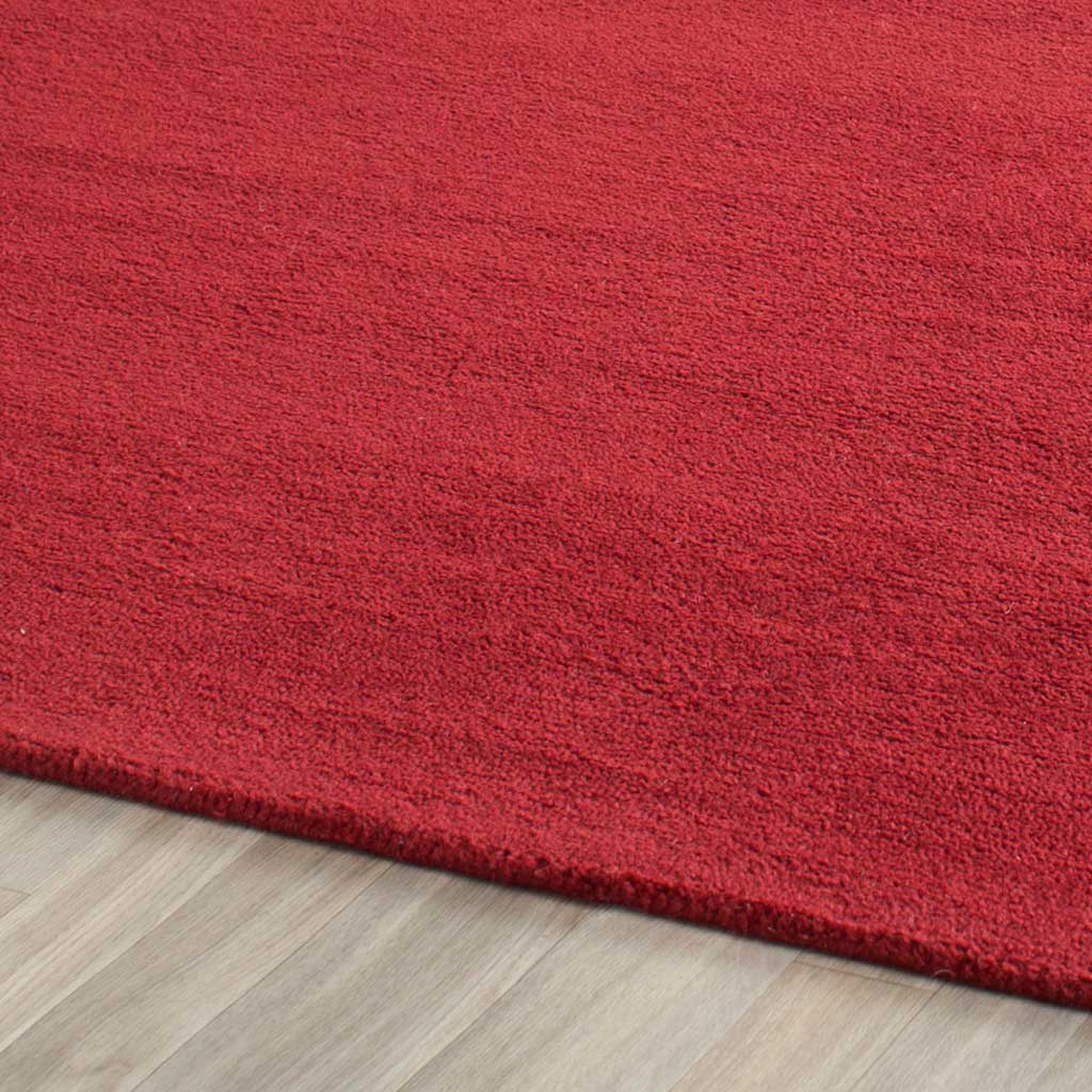 Fine red fibers form a dense, softly textured pile along a bound edge