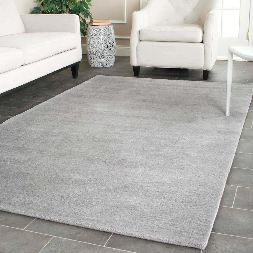 Versatile gray rug anchors light seating with a smooth, gently varied finish