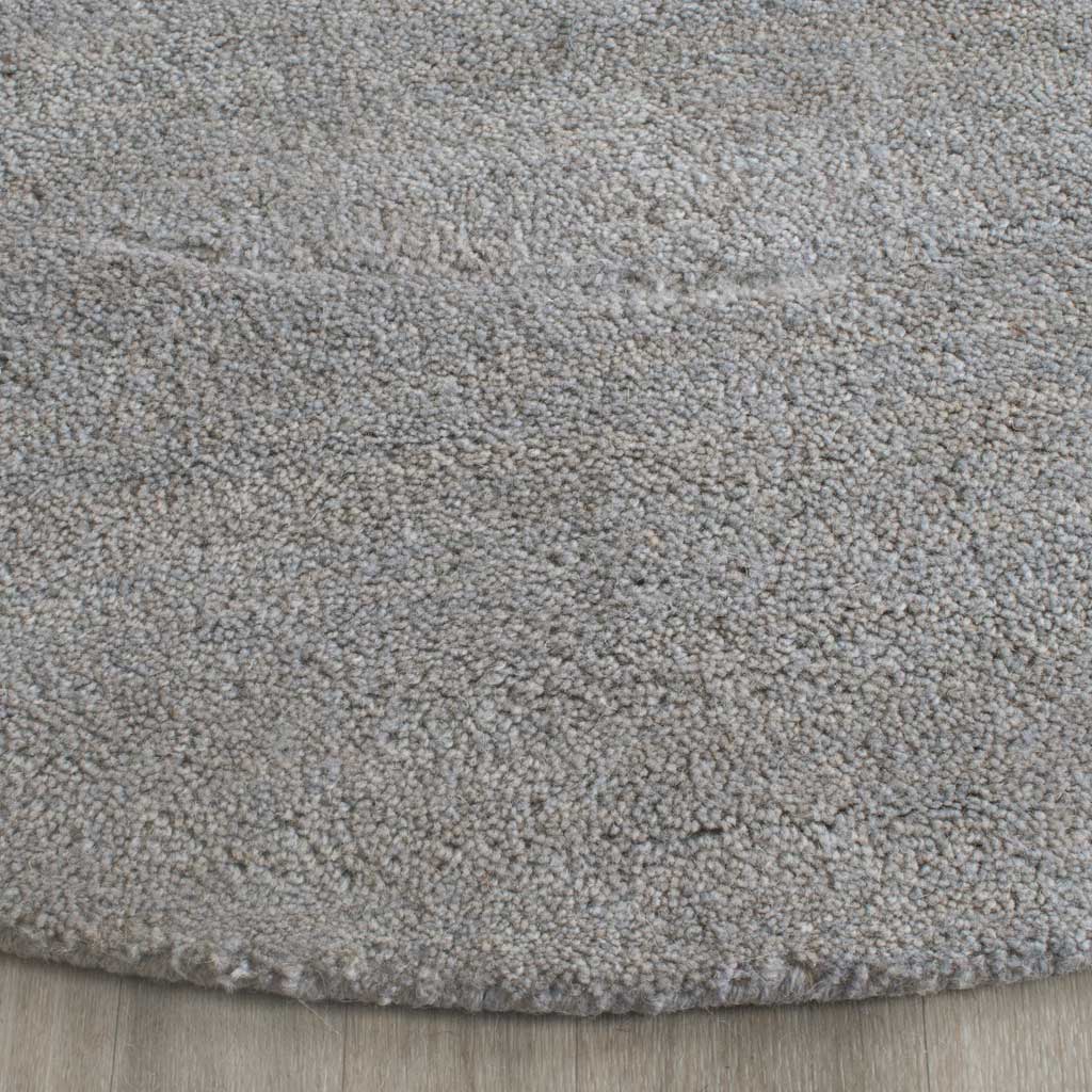 Dense gray fibers form a softly textured pile with a neatly finished edge