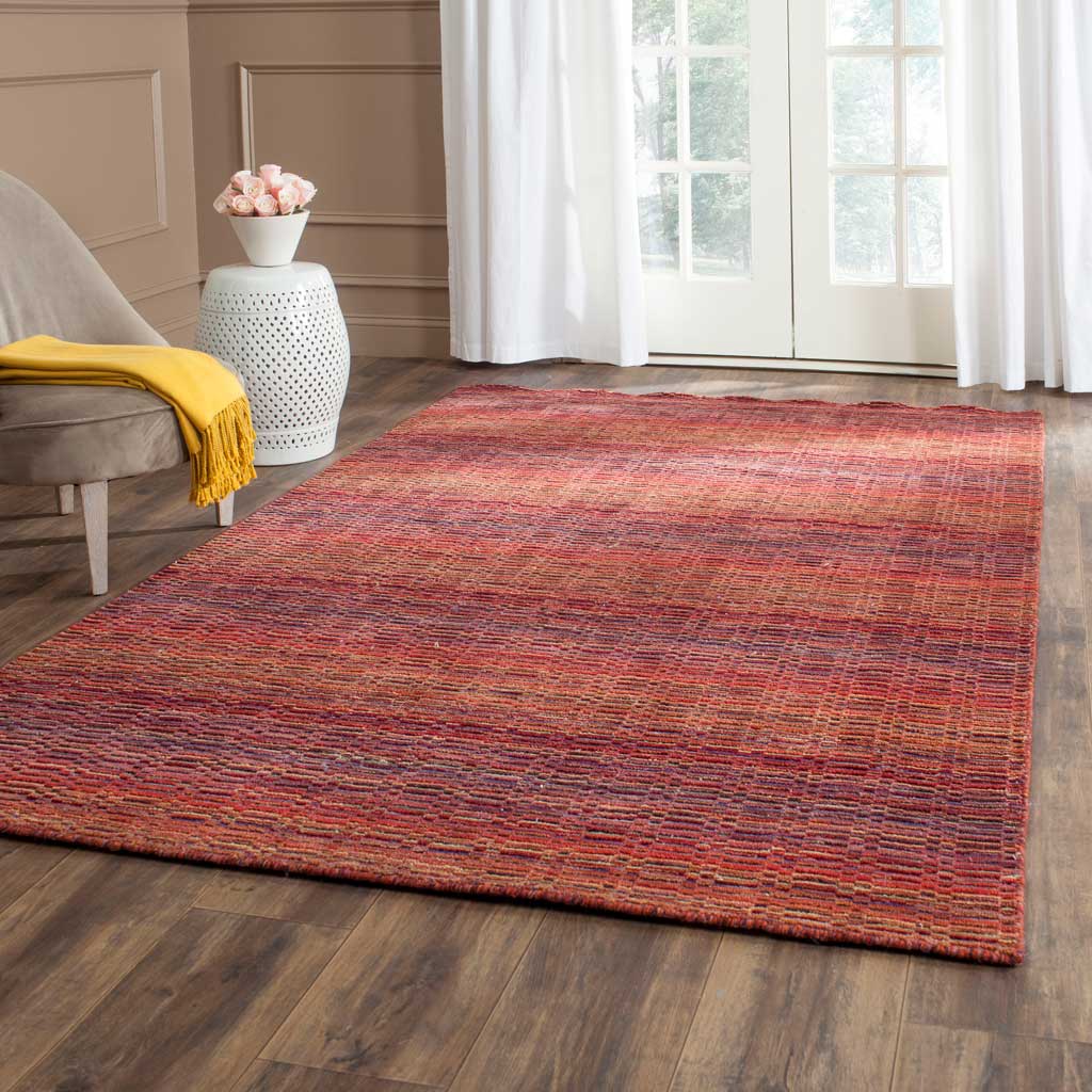 Richly striped red wool rug grounds a bright living space with vibrant warmth and woven texture