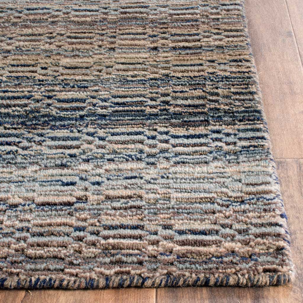 Chunky wool yarns and a finished edge highlight the rug's blue and beige stripes
