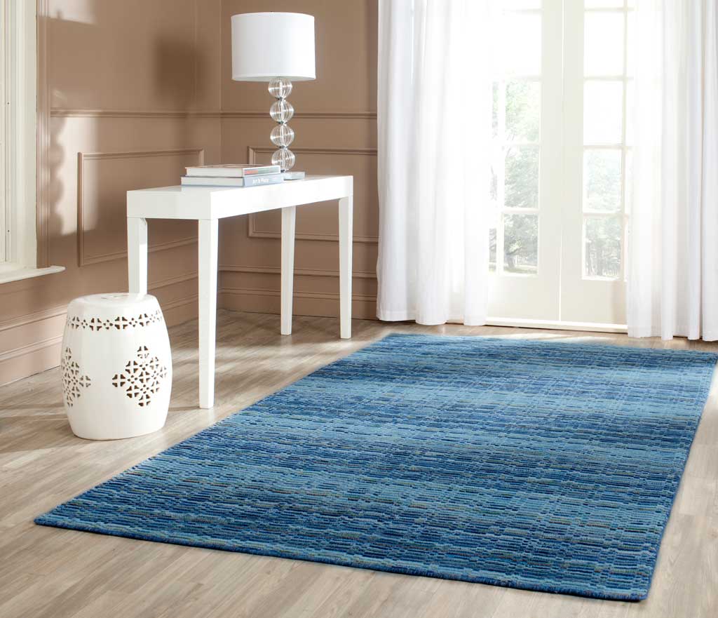 Blue striped wool rug adds layered color and texture to a bright, airy room