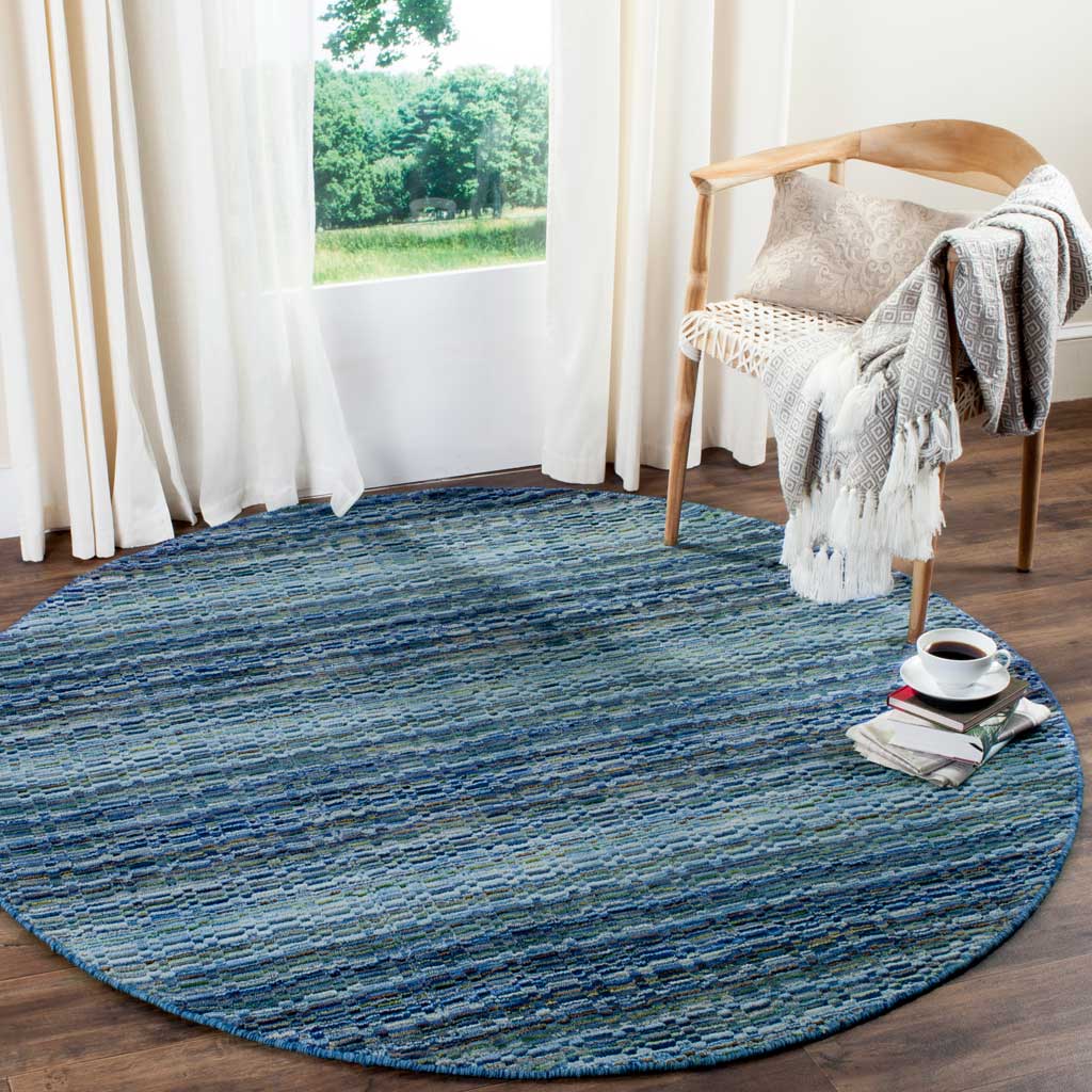 Round blue wool rug anchors a cozy seating area with calming, striated color