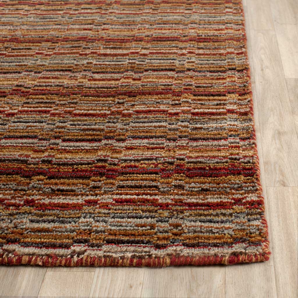 Rust and cream wool stripes end in a neatly finished edge with visible texture