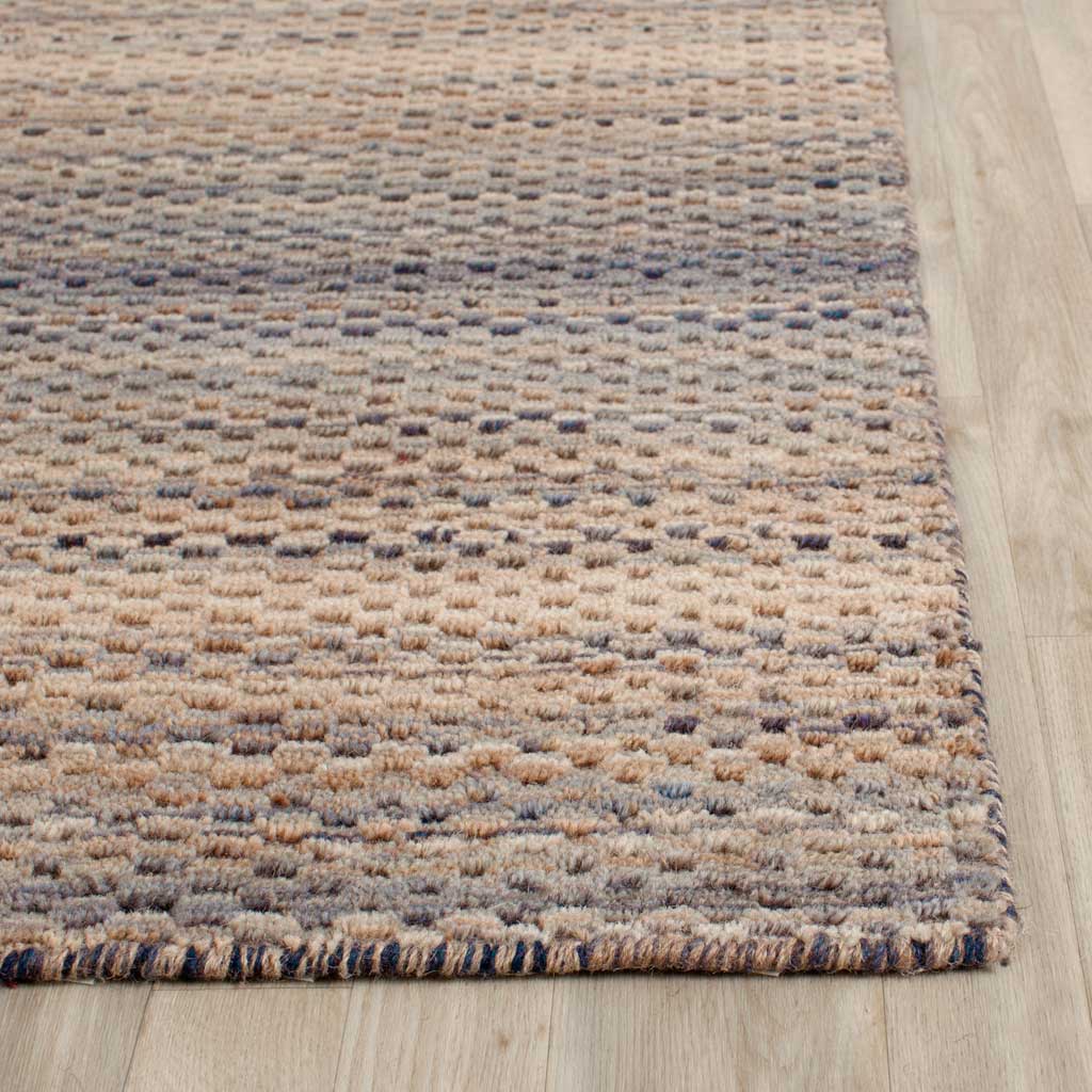 Raised gray and beige wool fibers add depth beside a neatly finished edge