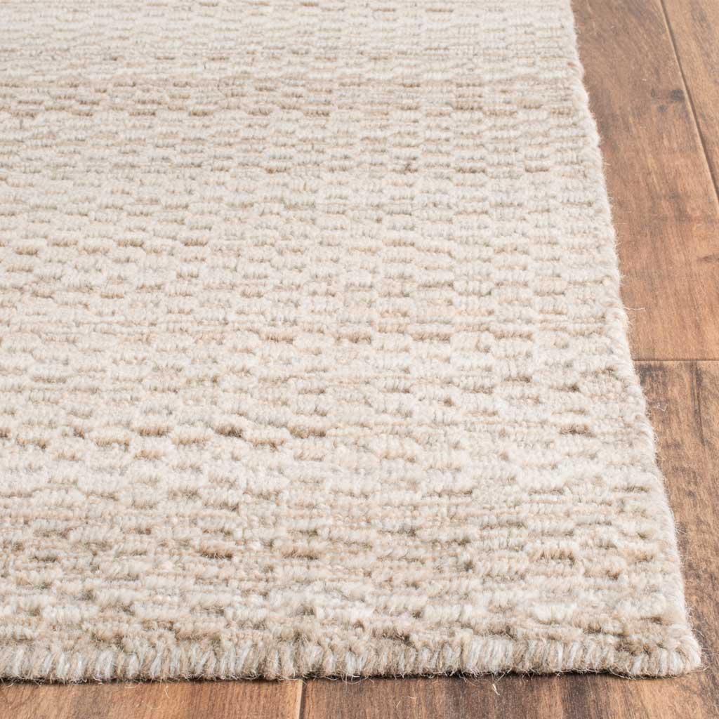 Nubby wool texture and a neatly finished edge add tactile appeal to this beige rug
