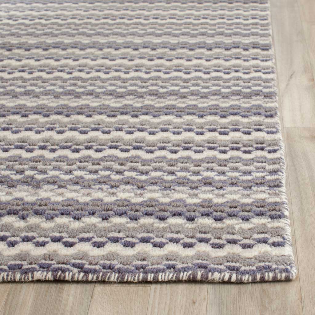 Textured beige and gray stripes meet a neatly finished edge on this wool rug
