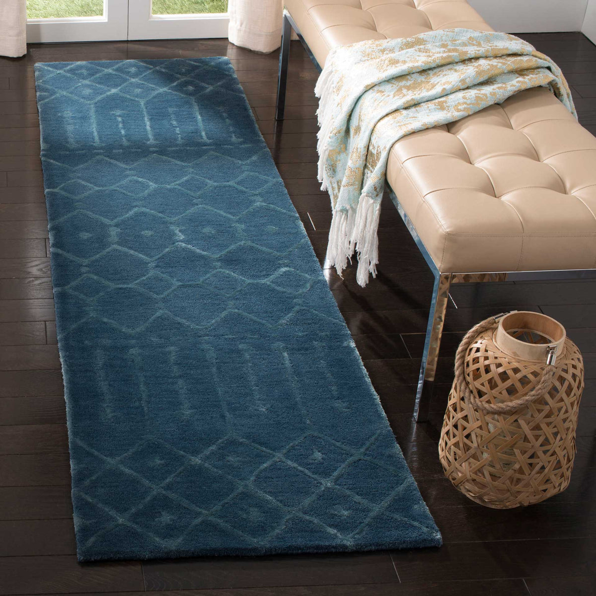 Navy geometric runner adds soft texture beside a tufted bench