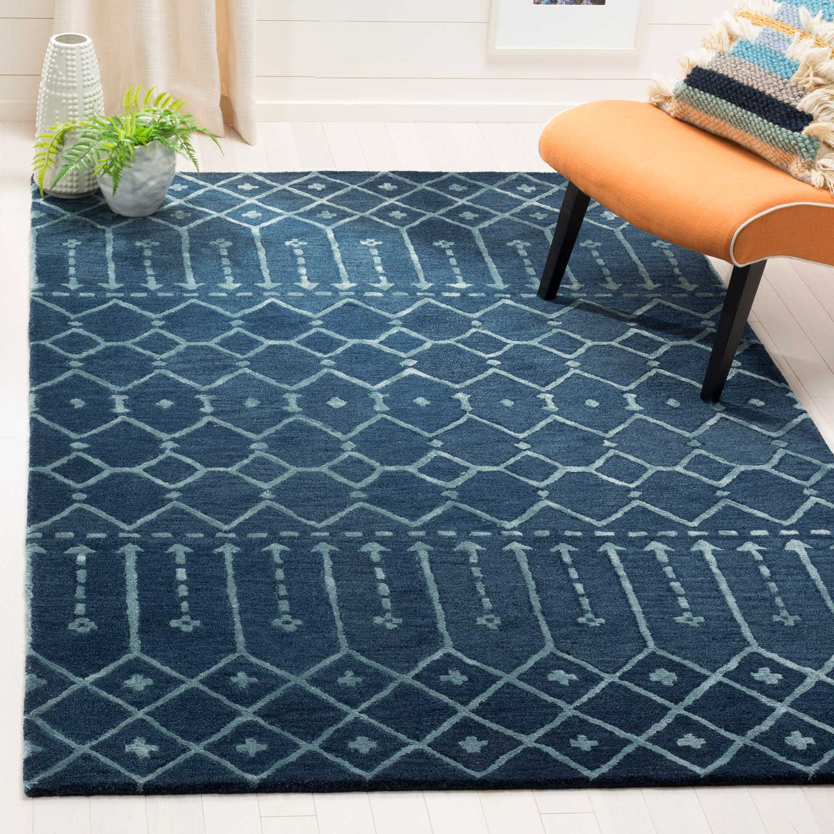 Navy and silver wool rug brings layered diamonds and elongated geometric motifs to the room