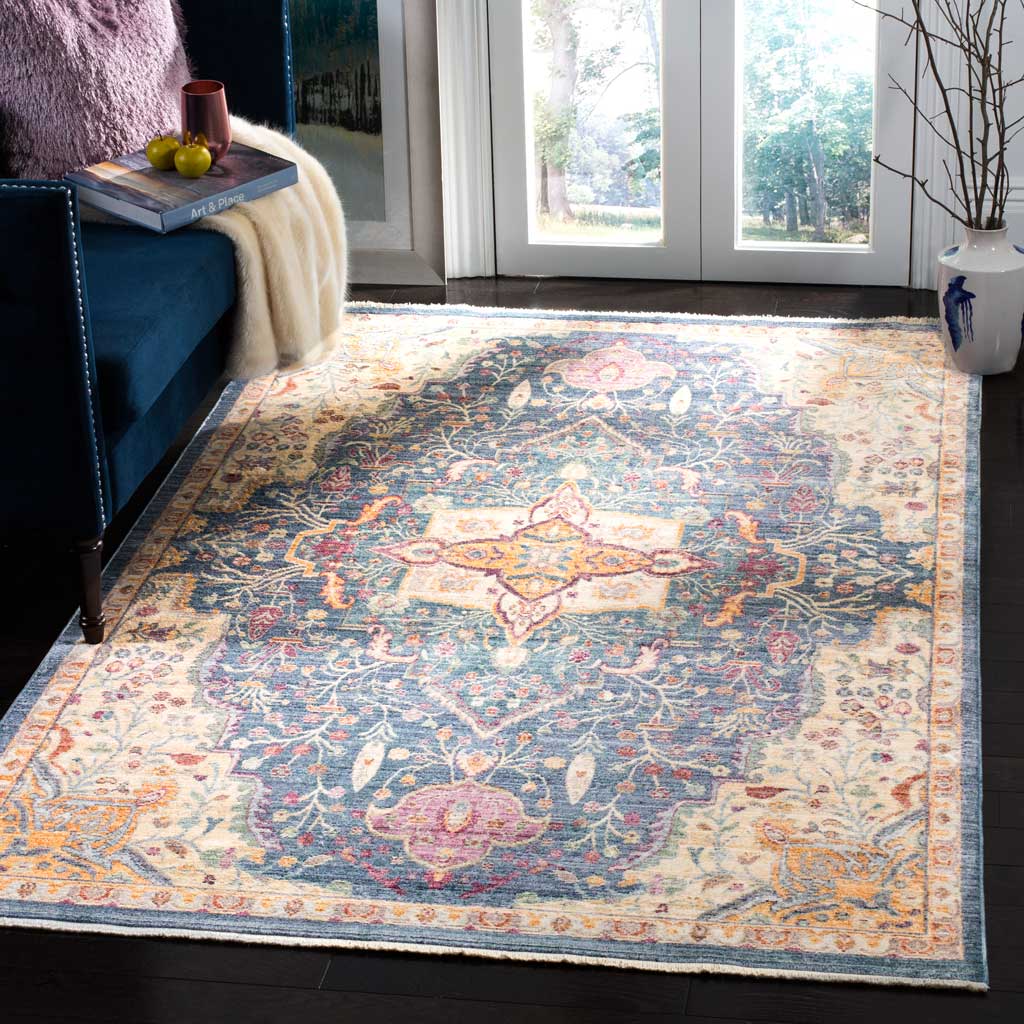 A colorful medallion and winding florals brighten this blue area rug beneath living room furnishings.