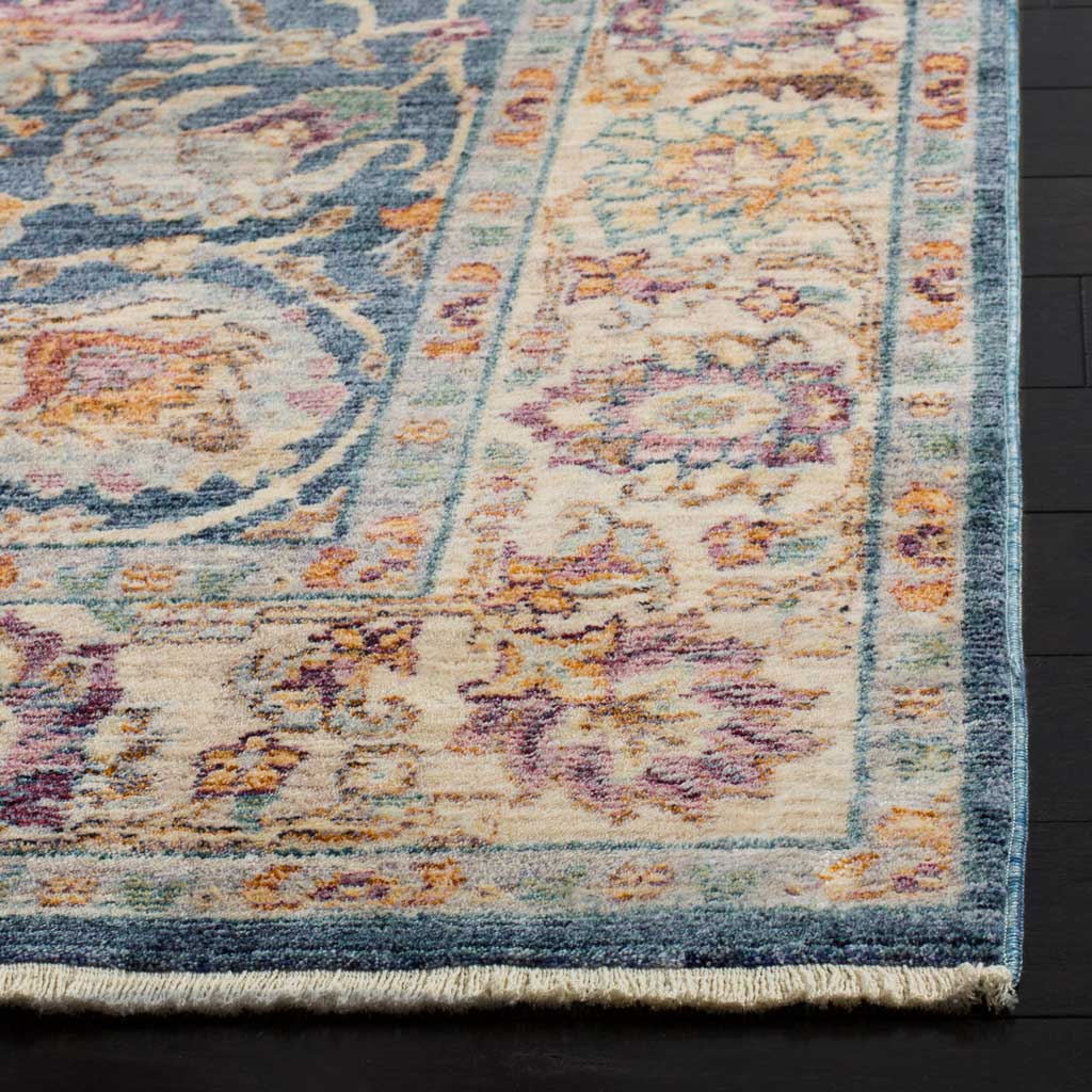 A floral border meets a short fringed edge, showcasing the rug's soft texture and layered color
