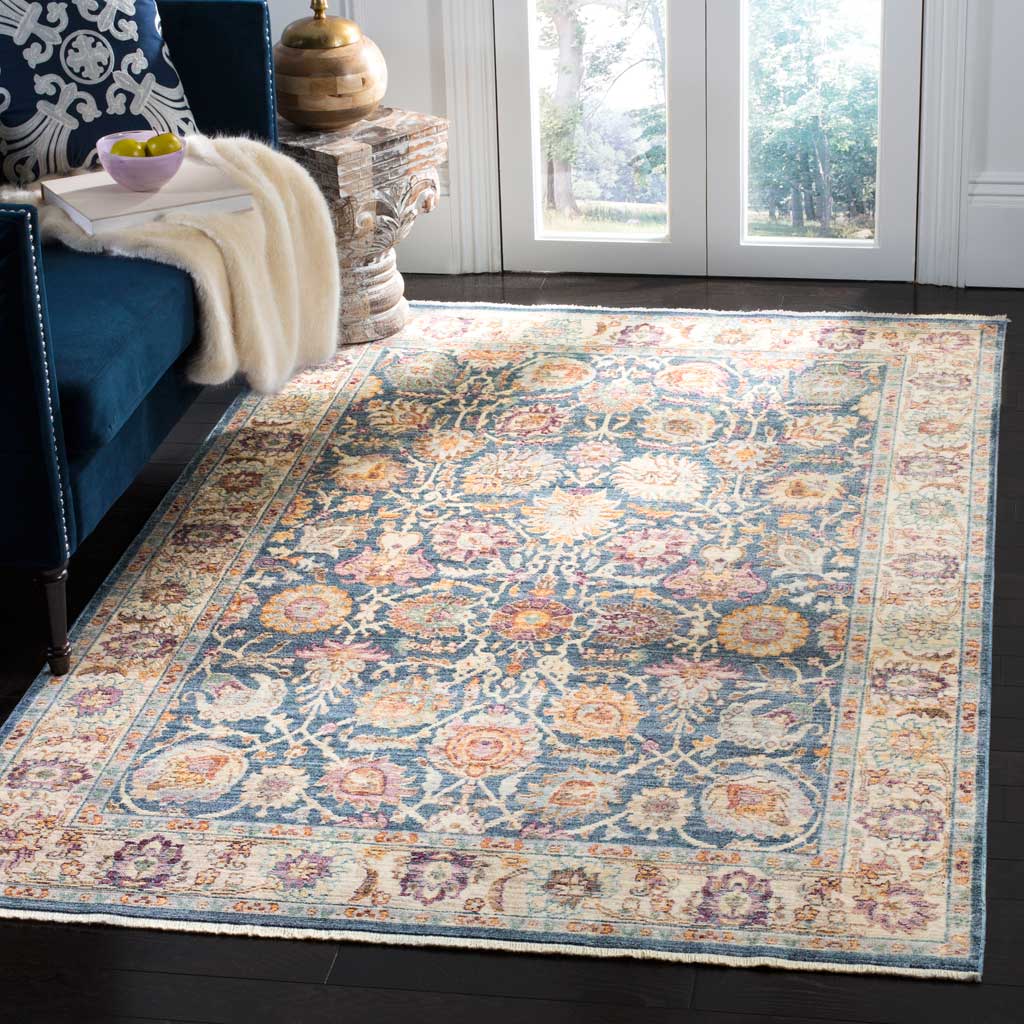 Blue and cream florals with warm blush accents bring classic charm to a bright living room